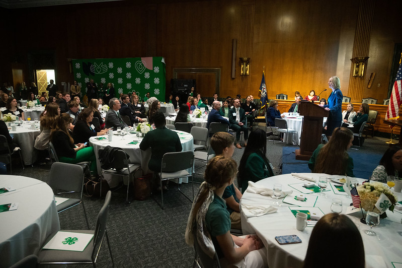 Texas 4-h students listen to a speaker during a presentation